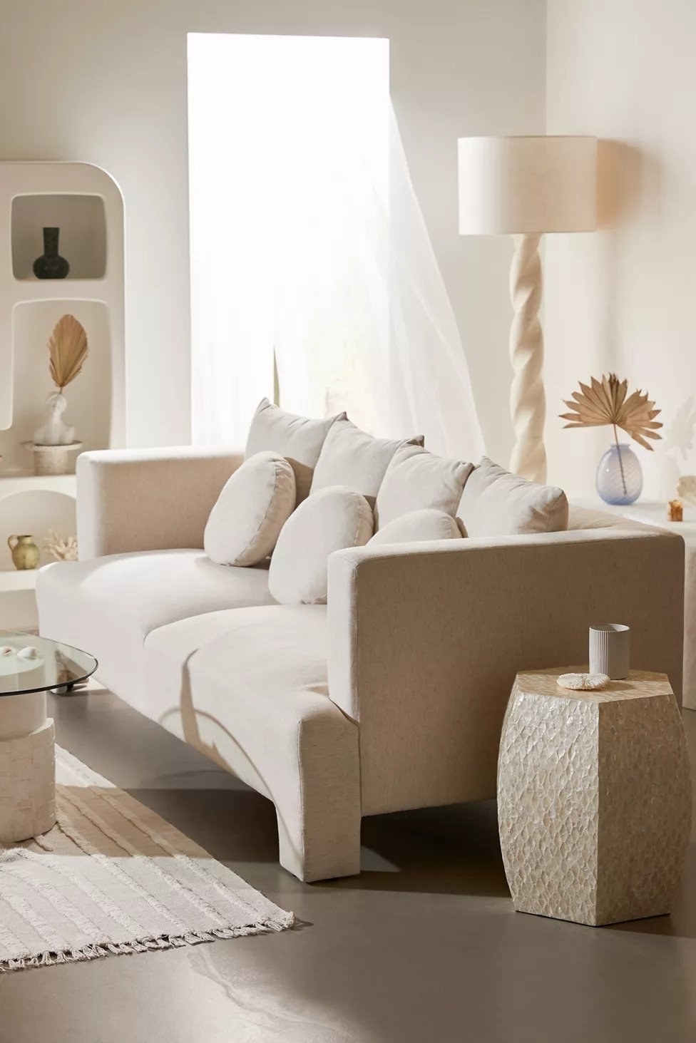 chunky sofa in room white white and beige decor