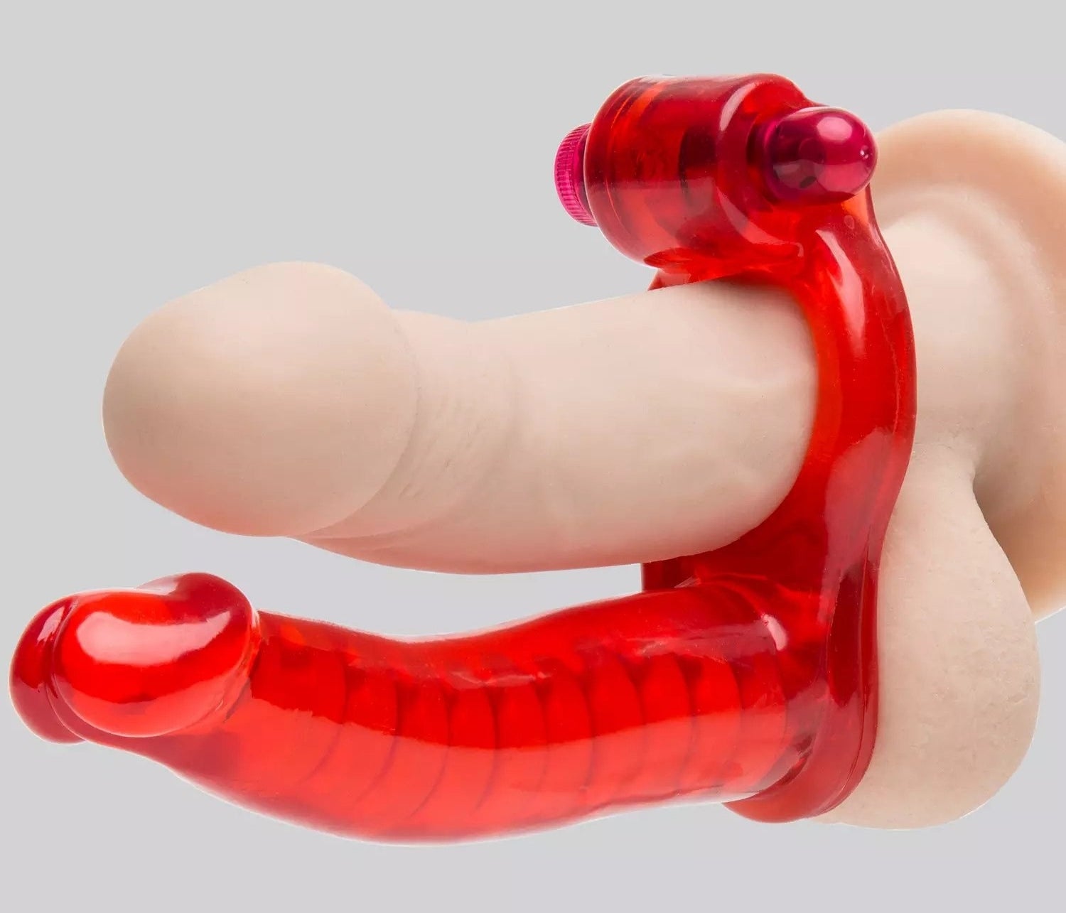 Red double penetration cock ring demonstrated on realistic dildo