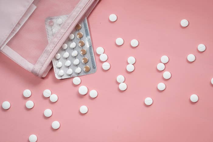 Stock image of birth control pills on a pink background