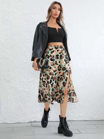 a model wearing the skirt in a green multicolor pattern