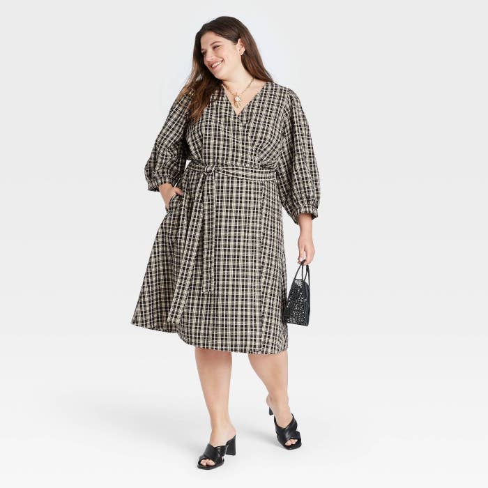 model wearing the plaid puff-sleeve wrap dress