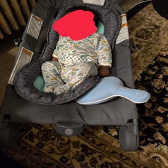 Reviewer's photo showing the blue pad placed inside a baby's rocker