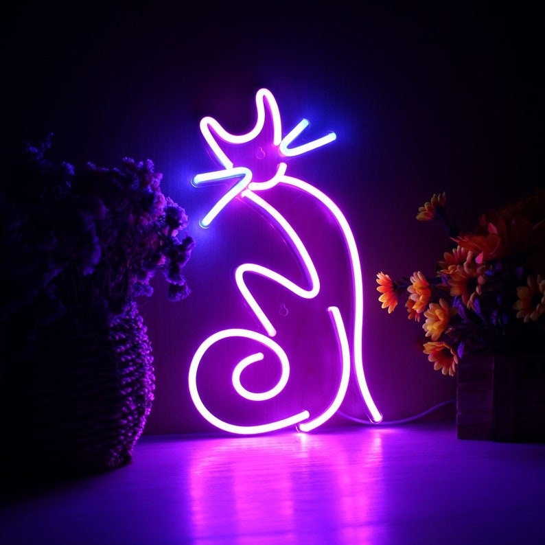 a purple neon light in the shape of a cat