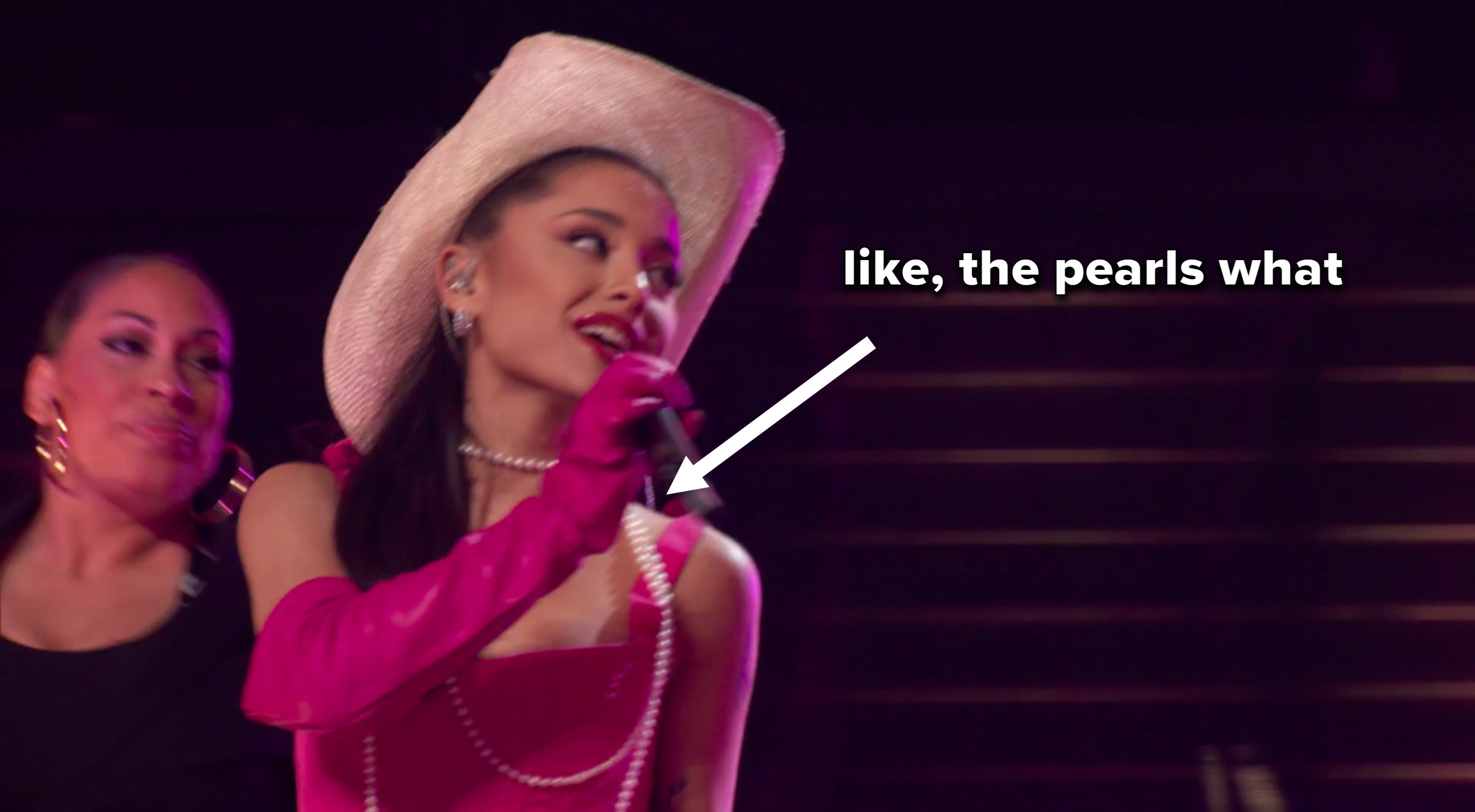 Ariana singing, with an arrow pointing from the caption &quot;like, the pearls what&quot; to the pearls she&#x27;s wearing