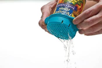 the colander on a can, showing how it gets the liquid out of a can