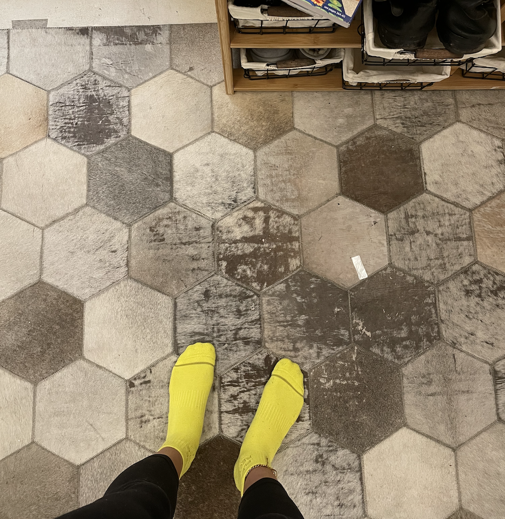 An image of the author&#x27;s shoeless feet as she stands in front of the entrance to Field Trip Health