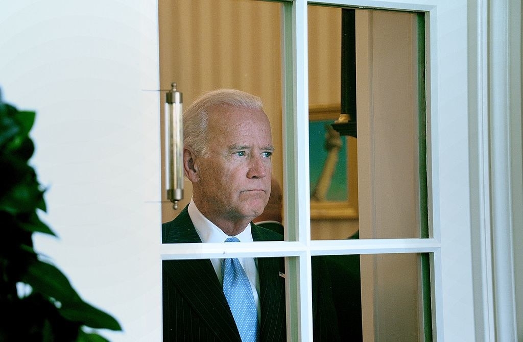 Joe Biden looking out the window of the white house