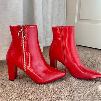 a reviewer photo of the boots in red with a side zip closure with a silver ring pull tab 