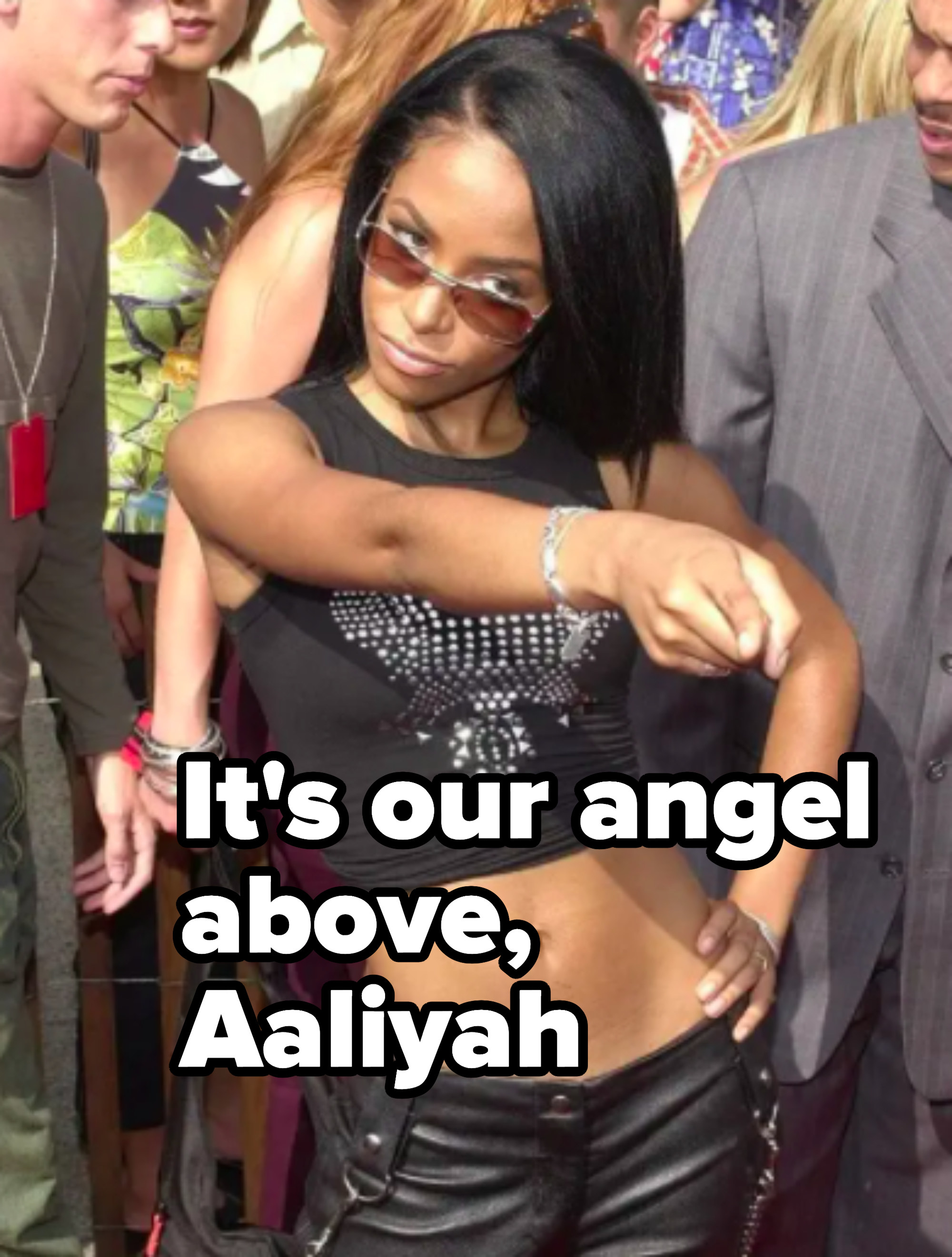 aaliyah is pointing on a red carpet