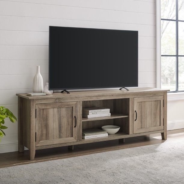 TV stand with accessories and a TV on it.