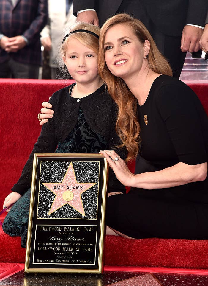Amy Adams (R) and Aviana kneeling and posing for photos at Amy&#x27;s star ceremony on the Hollywood Walk of Fame