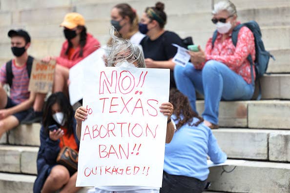 A protester with a sign that says &quot;no texas abortion ban&quot;