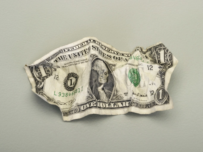 A crumpled up dollar bill
