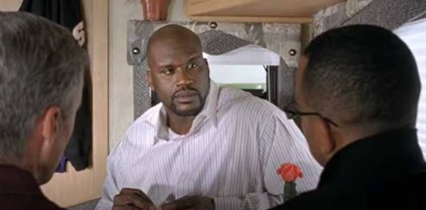 Inside an RV, Shaq mean mugs his scrabble opponents