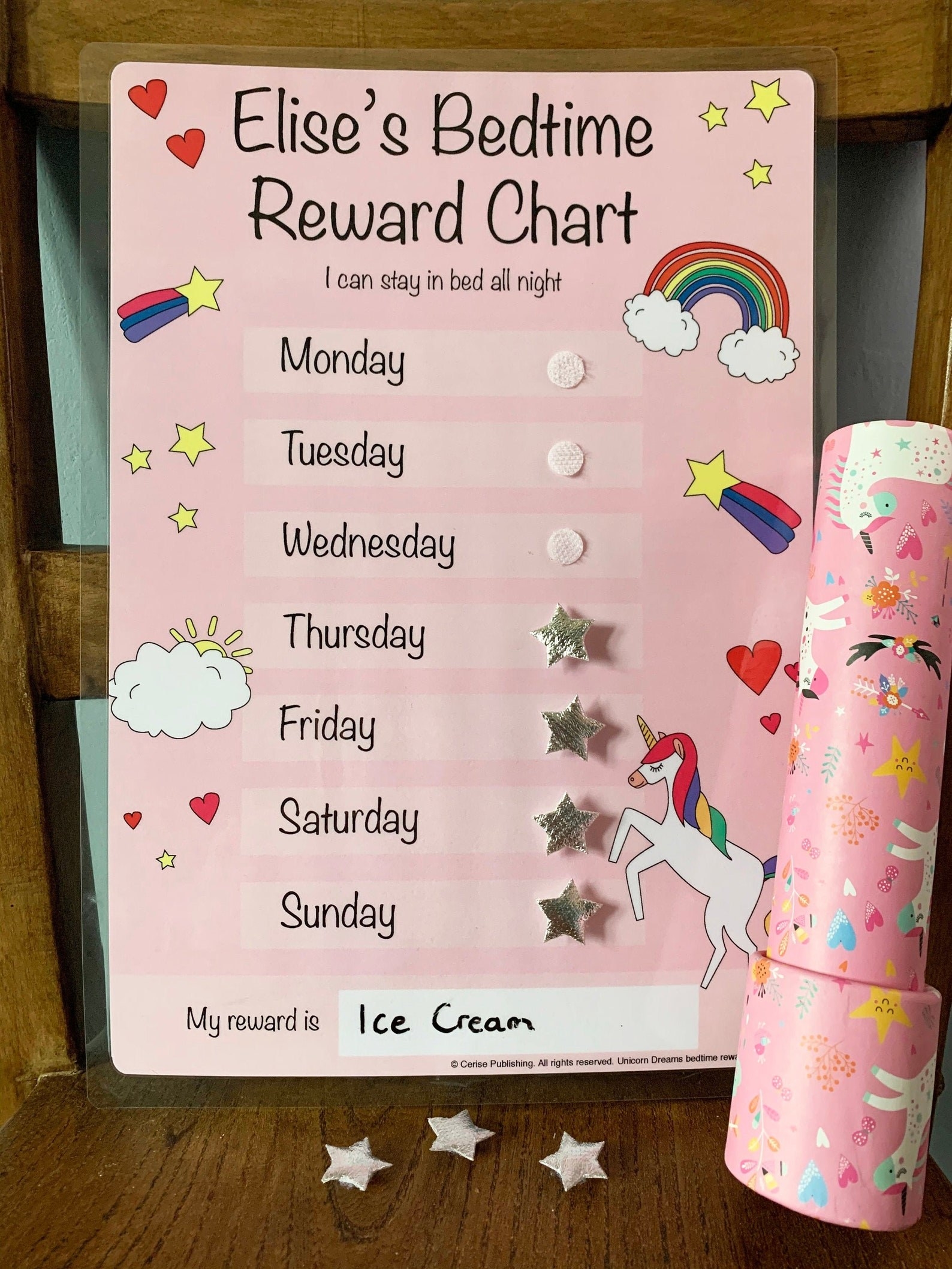 A pink chart with rainbows, unicorns and hearts and silver stars with a blank space to enter a reward at the bottom.