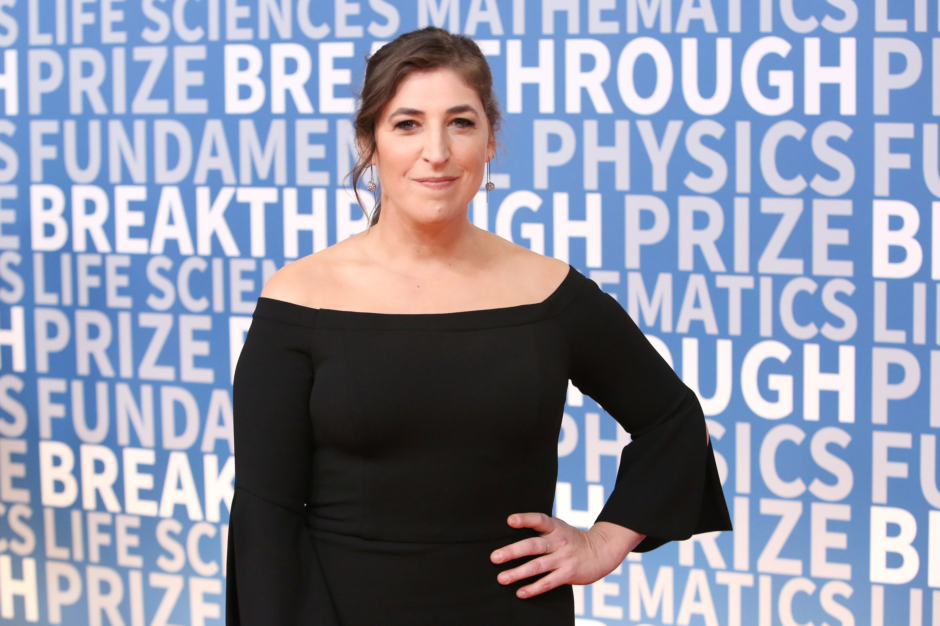 Mayim poses at an event