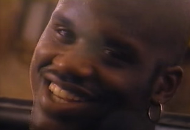 Shaq with an earring, smiling