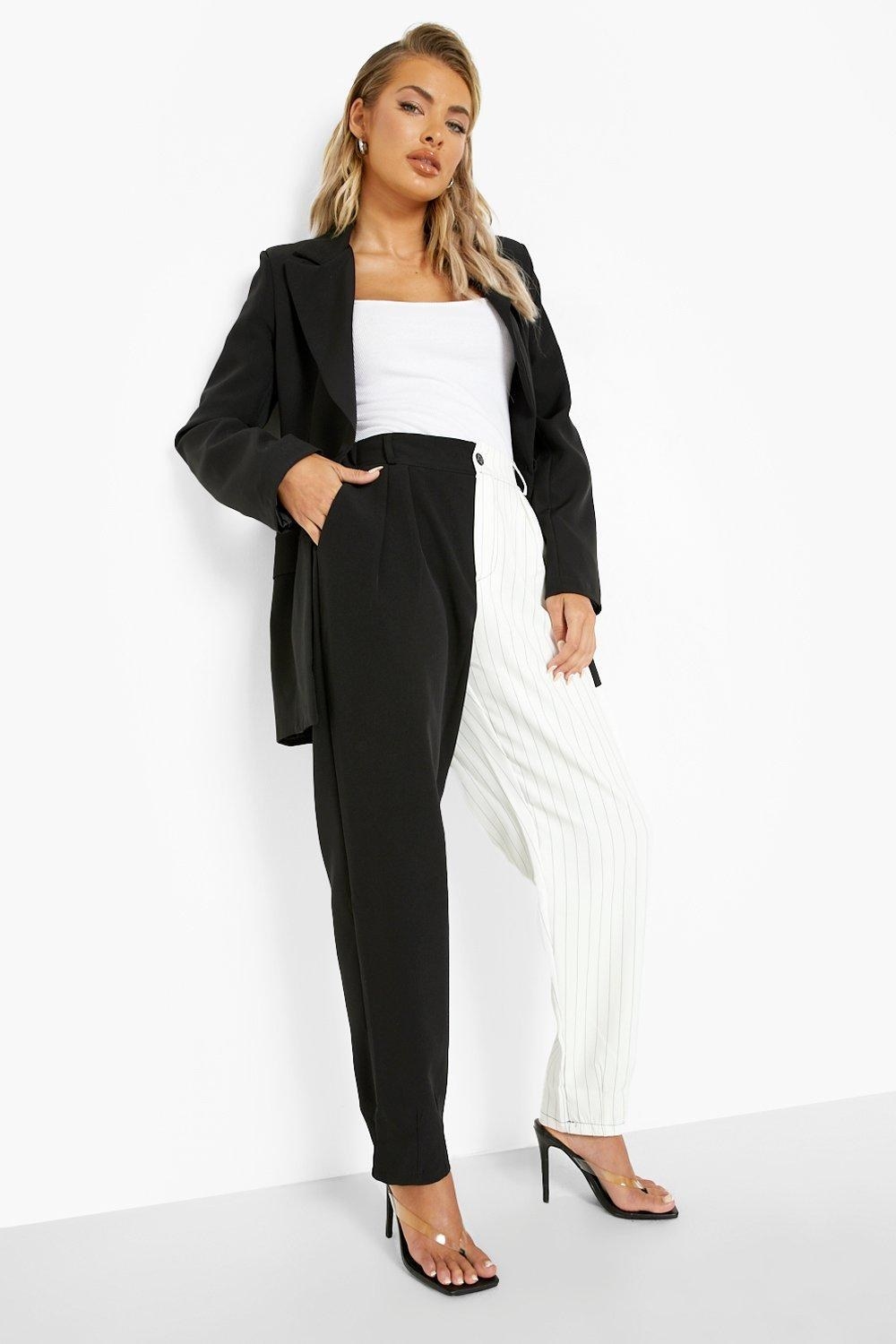 a model wearing the black and white spliced pinstripe trousers
