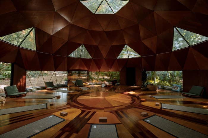 The interior features geometric shapes throughout the flooring and high cielings