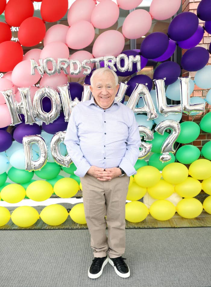 Leslie standing in front of a wall of multicolored balloons