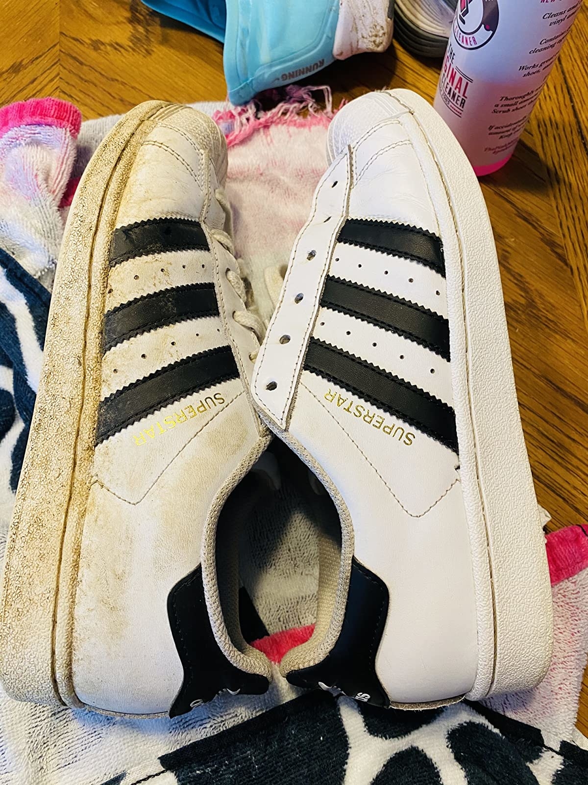 reviewer&#x27;s dirty adidas shoe on the left and a clean adidas shoe on the right