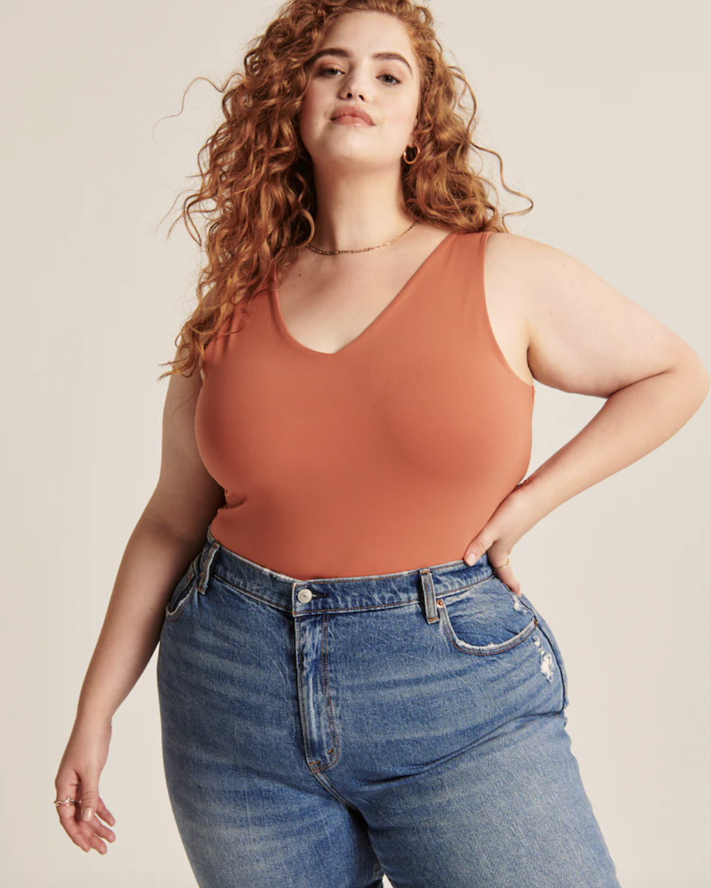 model wearing the bodysuit in orange