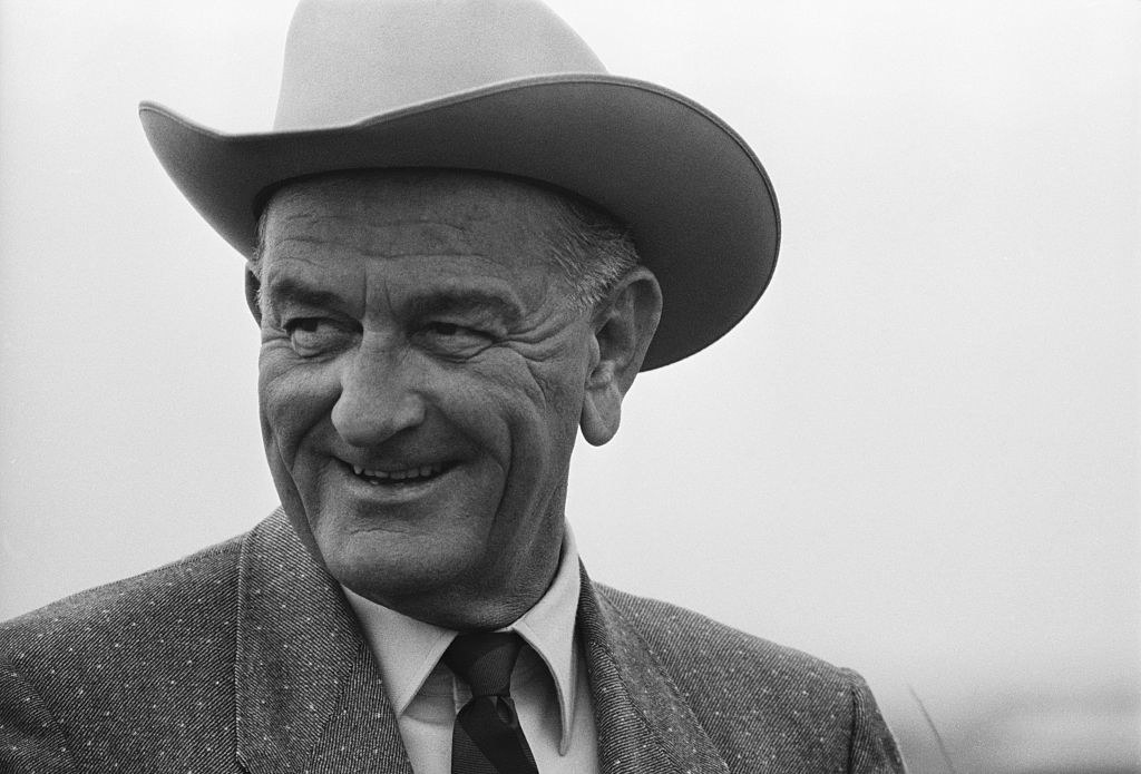 LBJ laughing in a cowboy hat