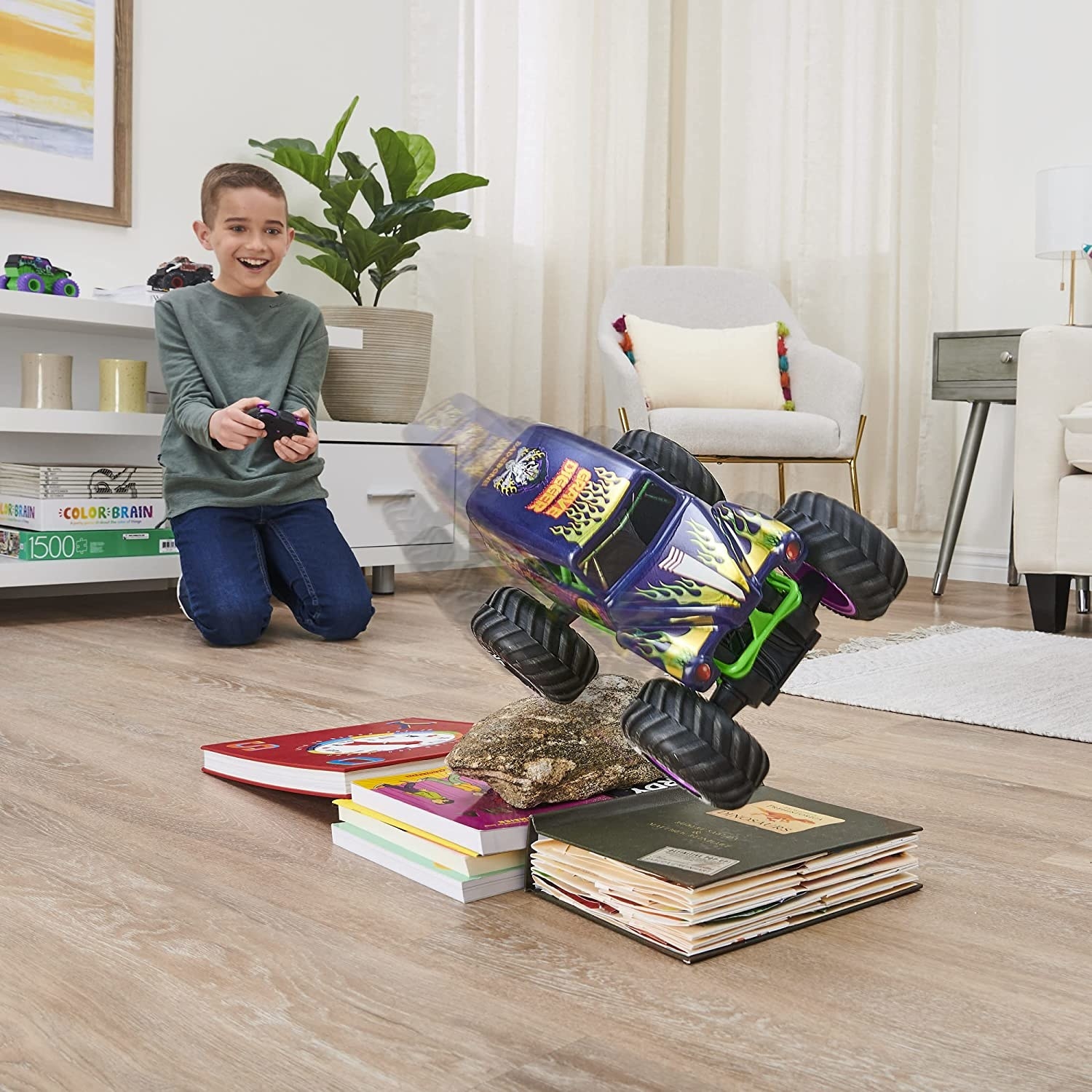 Child model playing with remote control Grave Digger truck