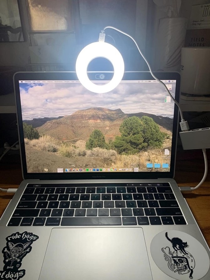 Mini selfie ring light clipped onto laptop