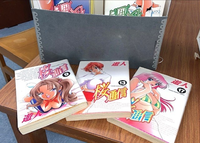 erotic manga displayed on a table