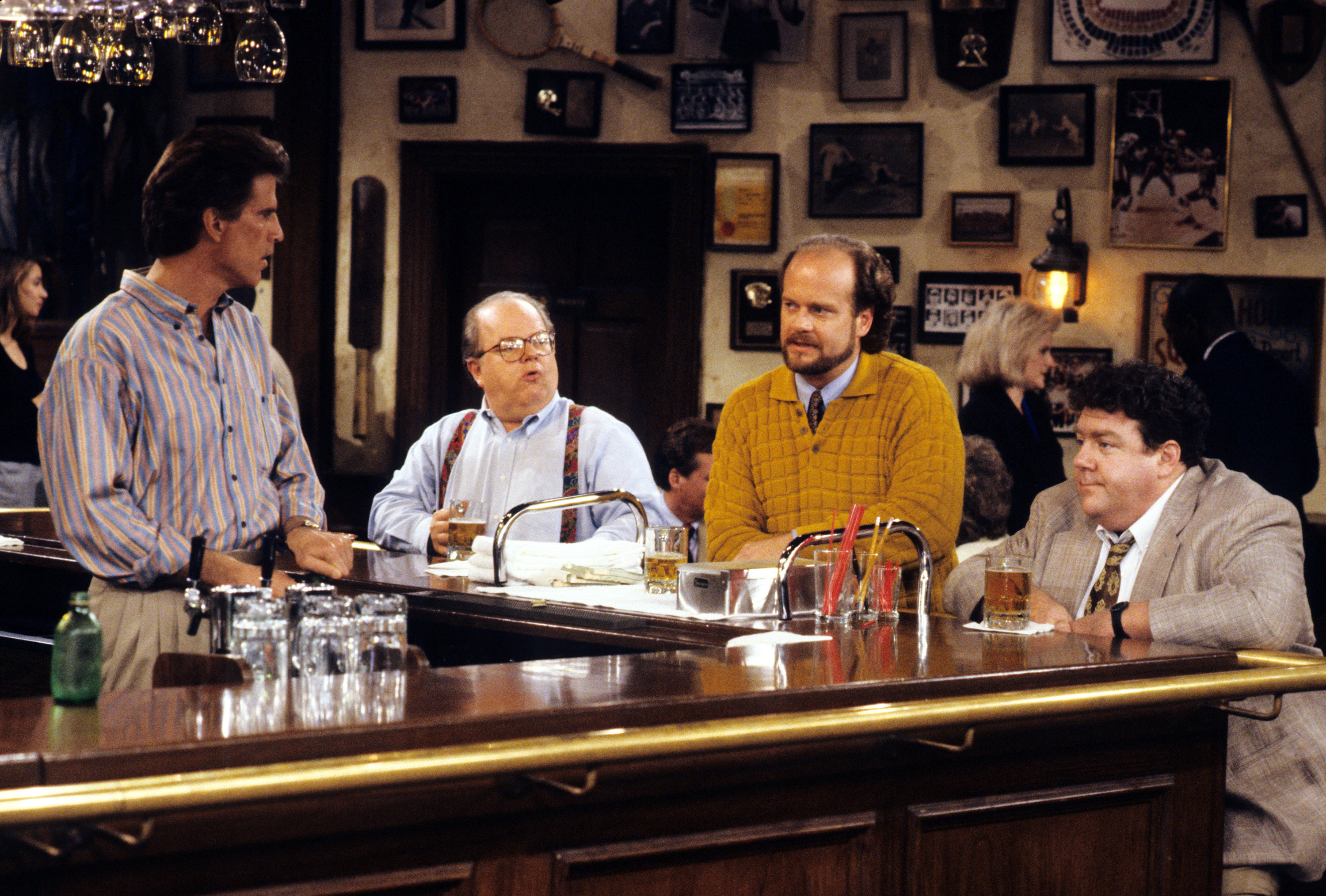 Ted Danson talking at the bar with Paul Wilson, Kelsey Grammer, and George Wendt.