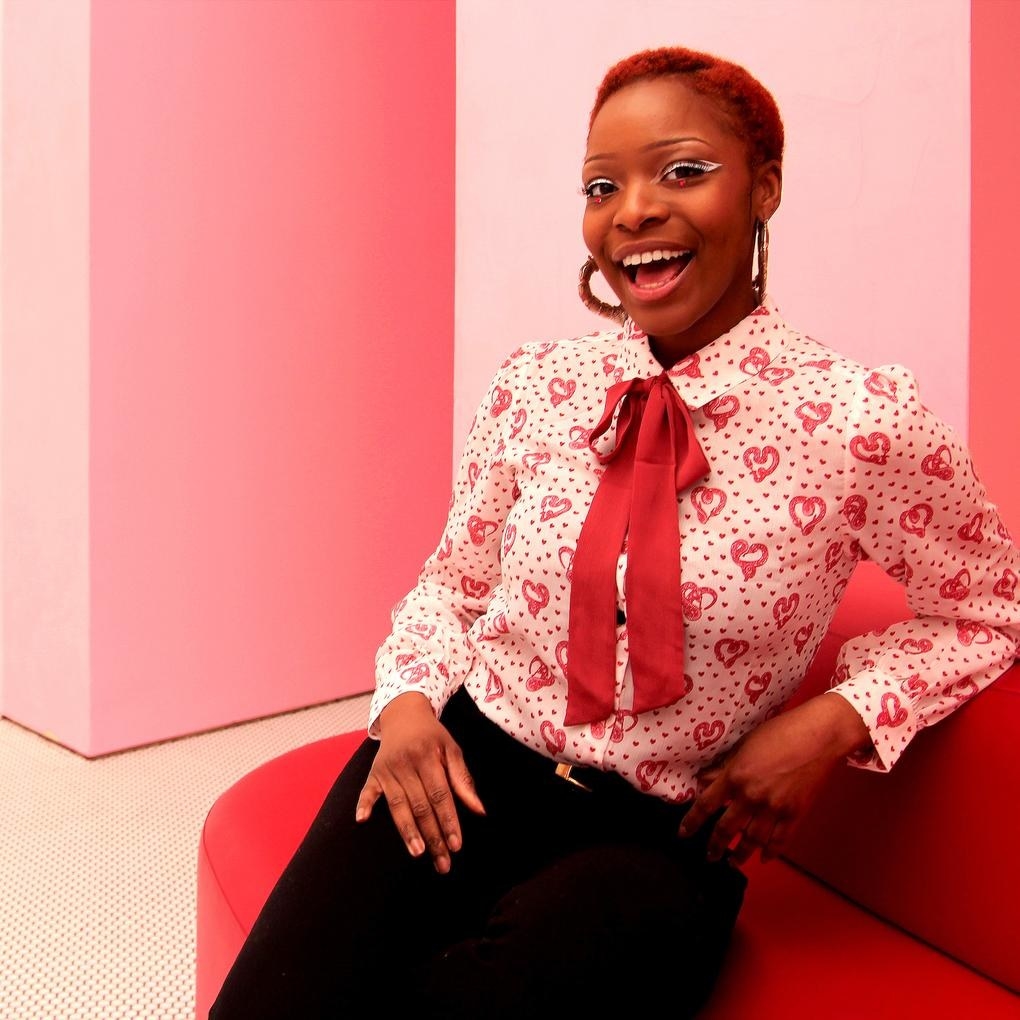 model wearing the red and white blouse