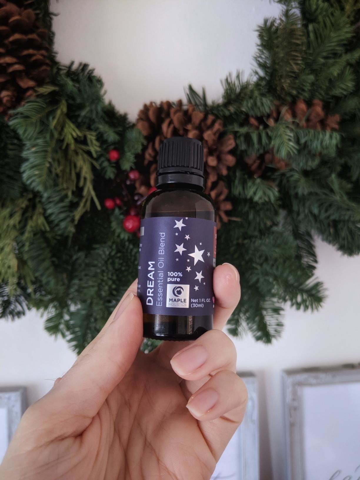 Reviewer holding a bottle of the essential oil blend