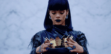 Rihanna placing a crown on her head