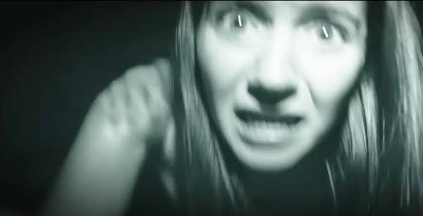 a woman looking panicked while looking at the camera