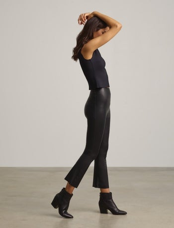 Model wearing black cropped flare leggings