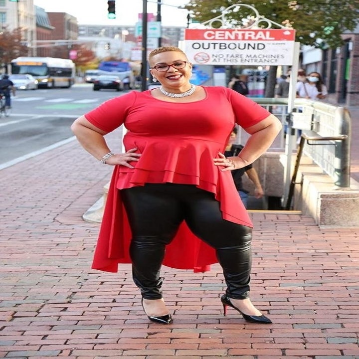 reviewer wearing with red shirt and black pumps