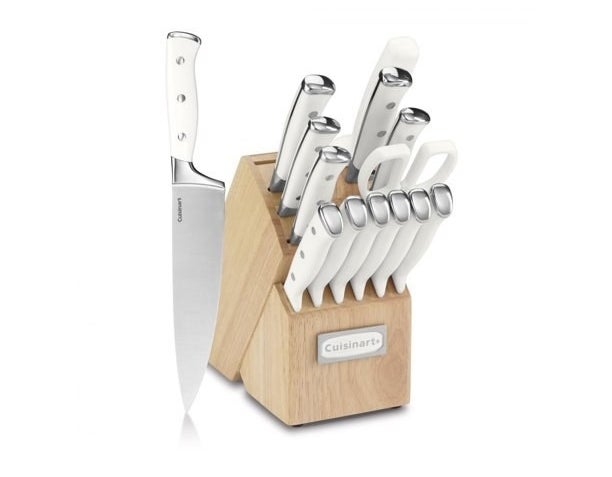 Knife block set stocked with knives, one knife standing up in front of it.