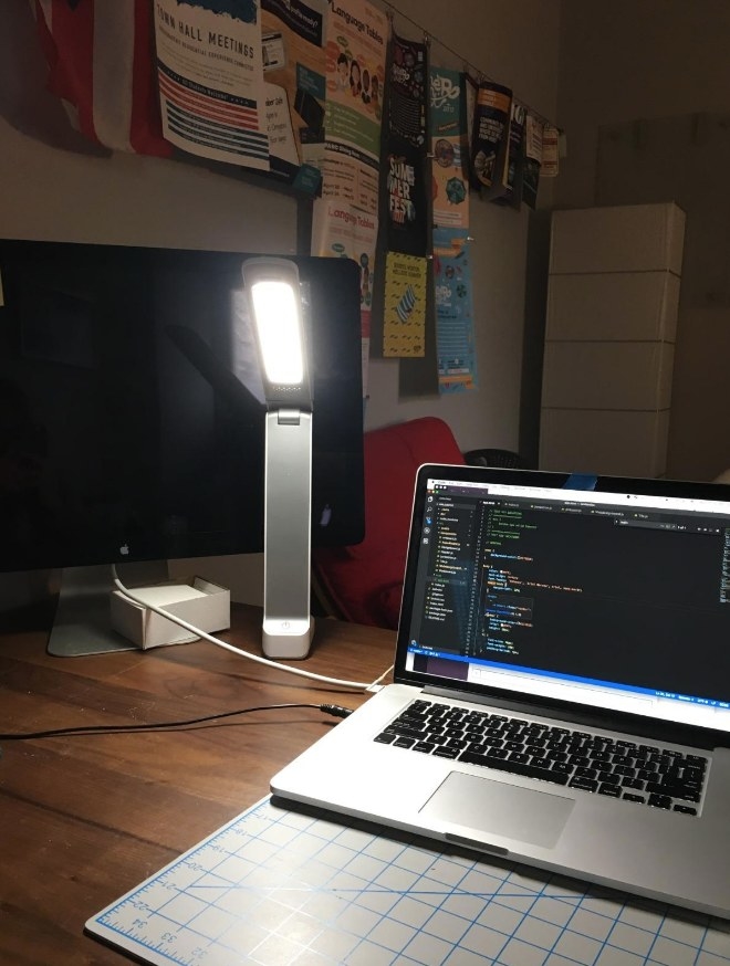 Therapy lamp on desk next to laptop