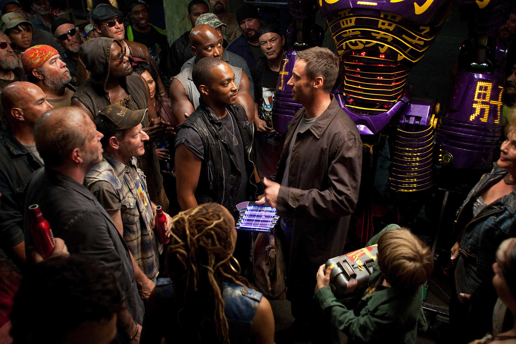 A group of people standing around in a scene from Real Steel