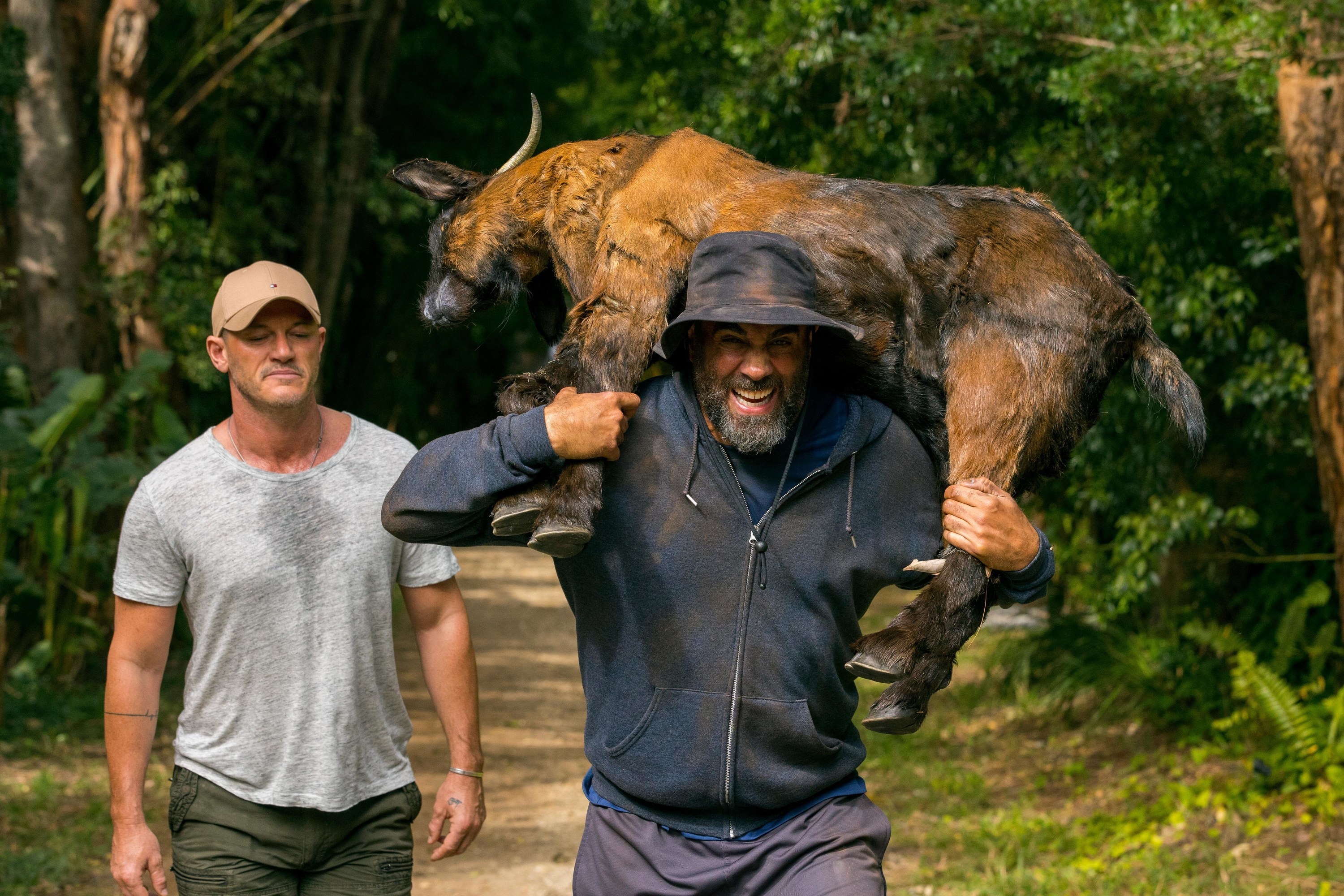 A man carying a goat around his shoulders