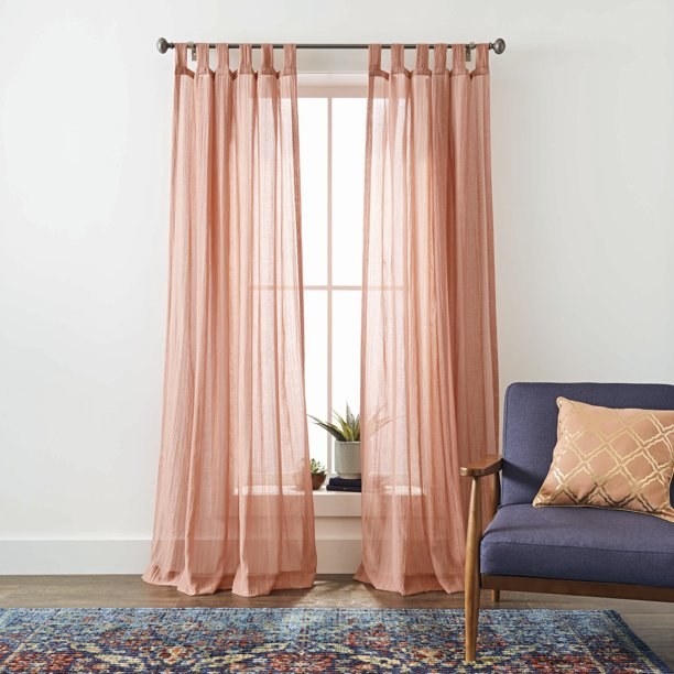 the orangey pink curtains in a living room