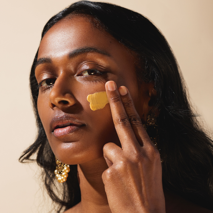 A South Asian model applying the sunscreen