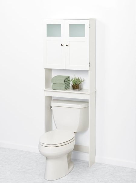 The bathroom organizer with an open shelf and additional storage, directly above a toilet in a bathroom