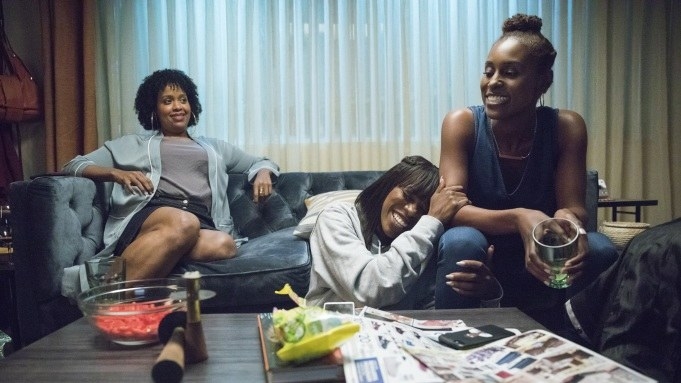 Natasha Rothwell, Yvonne Orji, and Issa Rae having a laugh on the couch.