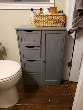 Reviewer photo of the grey organizer in their bathroom