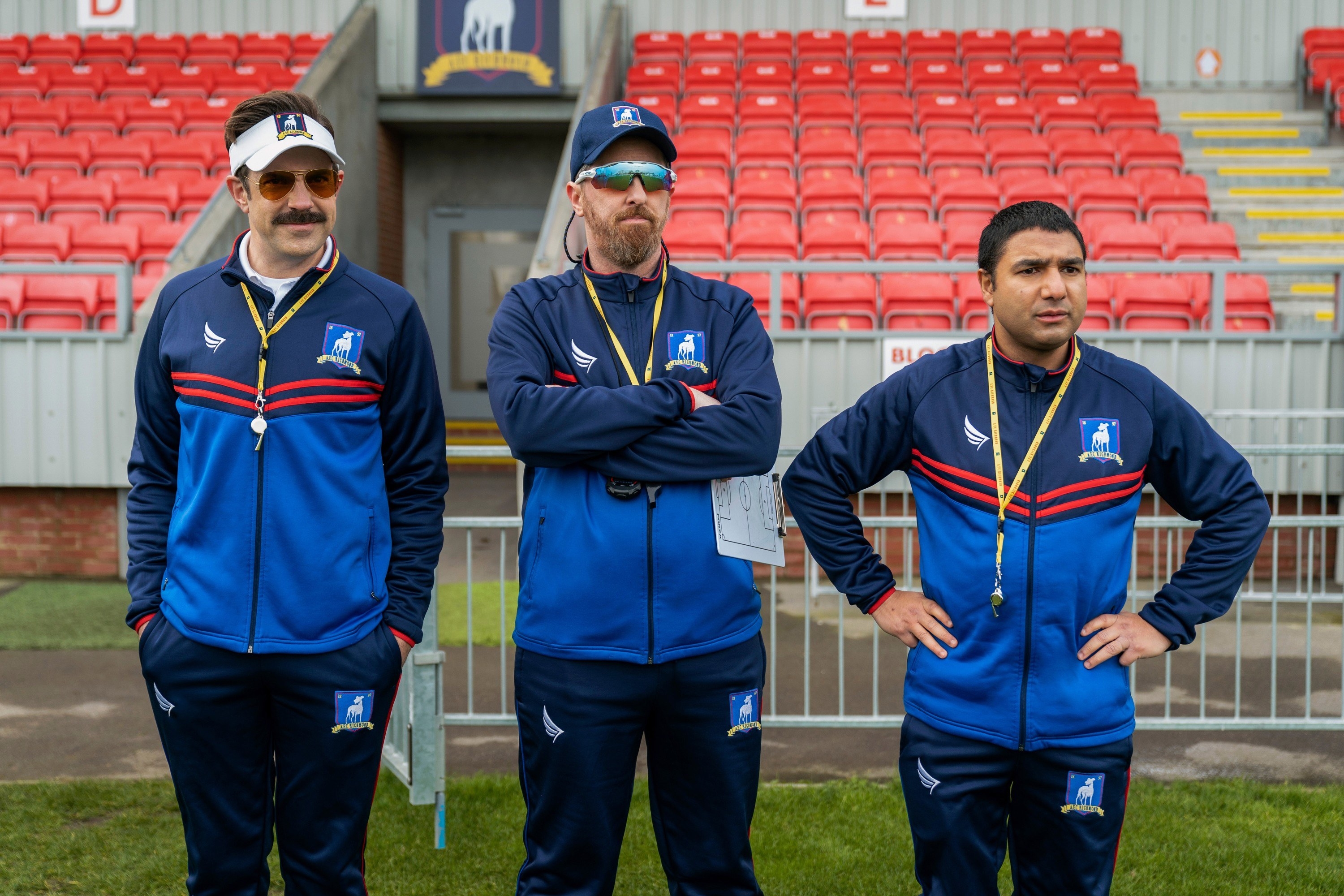 Jason Sudeikis, Brendan Hunt, and Nick Mohammed on the sideline.