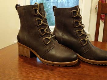 a reviewer photo of the boots in brown sitting on a table 