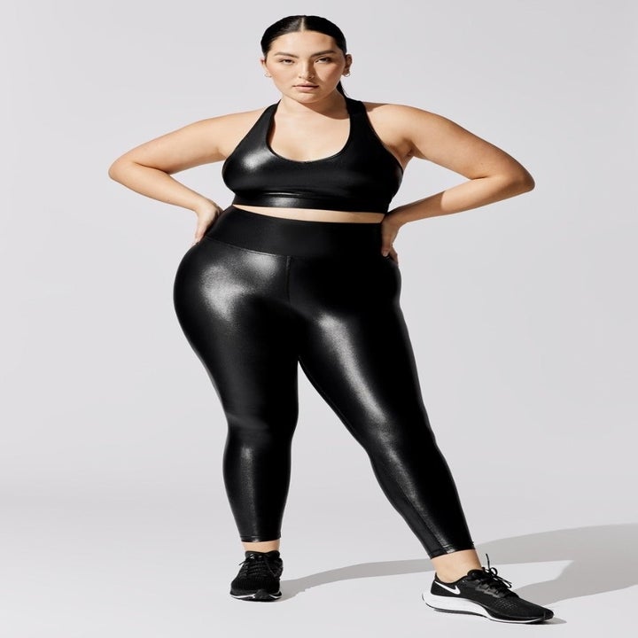 Model wearing black faux leather leggings