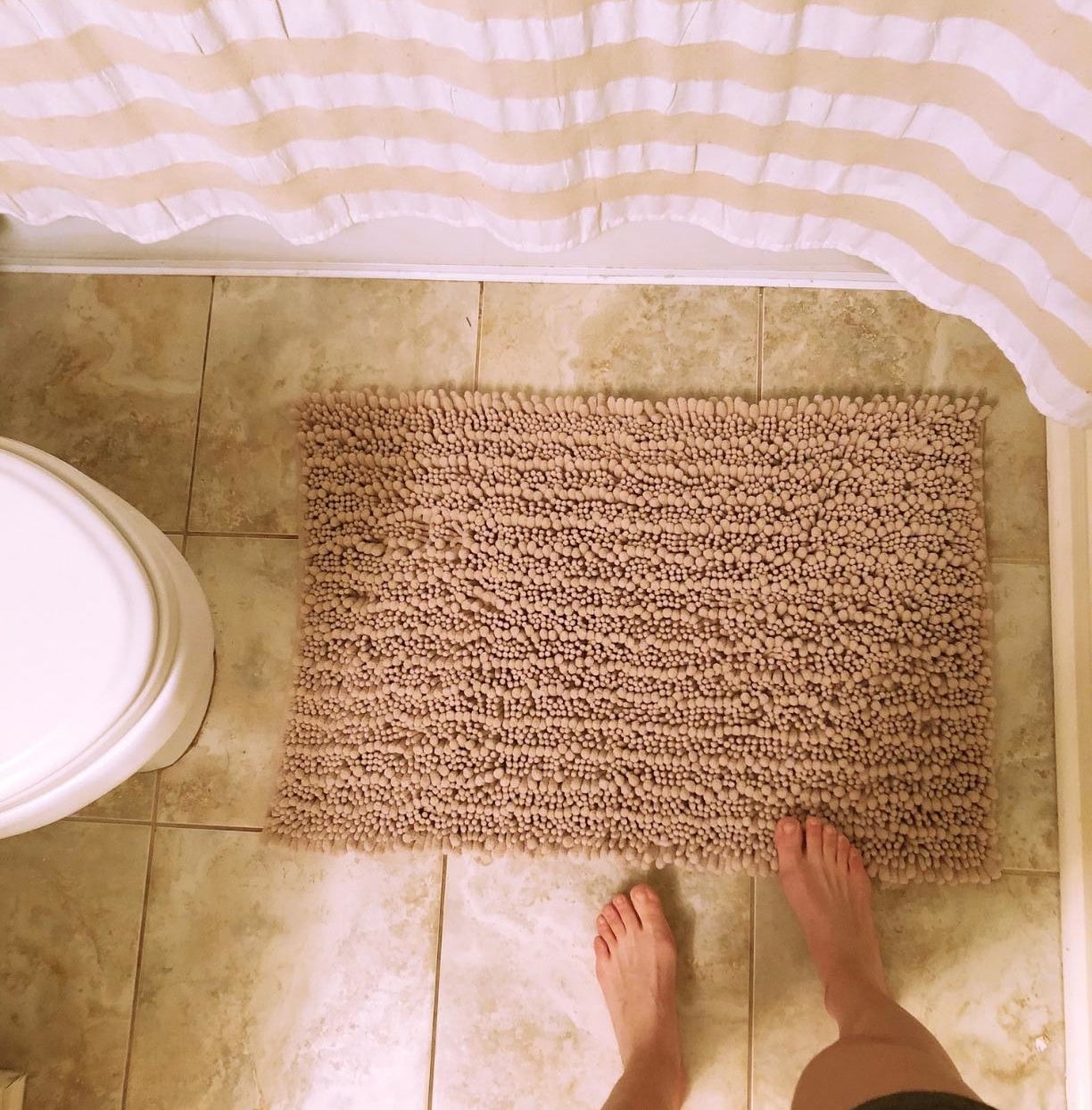 Reviewer photo of the bathmat on the floor in front of their tub